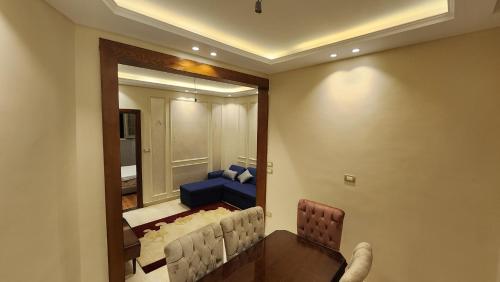 a living room with a couch and a mirror at Azarita luxury apartment - families only in Alexandria