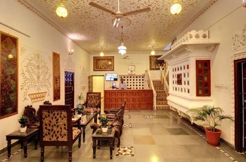 a lobby with chairs and tables in a building at Hotel Darbargarh A Unit of Khamma Ghani A Boutique Hotel in Udaipur