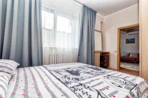 um quarto com uma cama e uma janela em Жк Нурсая вблизи Байтерека em Astana