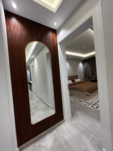 a mirror on a wall in a bedroom at Self check in Unique 3 Bedrooms Apartment in Riyadh
