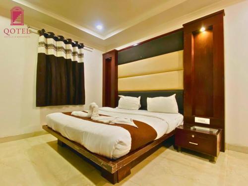 Ένα ή περισσότερα κρεβάτια σε δωμάτιο στο Qotel Express Sandberry Prashant Vihar
