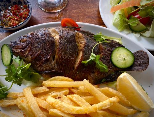 a plate of food with a steak and french fries at Bannister Hotel in Johannesburg