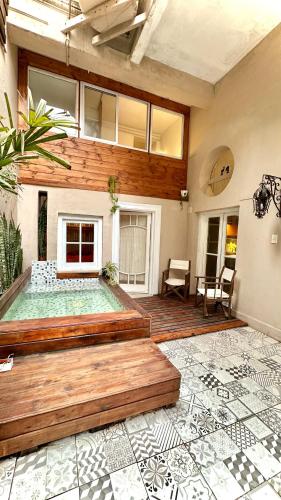a house with a large deck with a swimming pool at CASA CENTRICA - experiencia casa pasillo paseo del siglo in Rosario