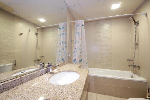 a bathroom with a sink and a bath tub at SHH - Furnished 1BR Apartment in Goldcrest Executive, Jumeirah Lake Towers in Dubai
