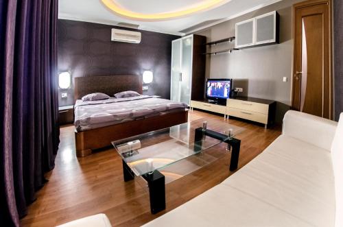 1 dormitorio con cama y mesa de cristal en Бульвар Леси Украинки 16 джакузи люкс центр, en Kiev