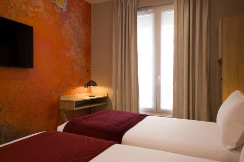 Кровать или кровати в номере Hotel Charlemagne