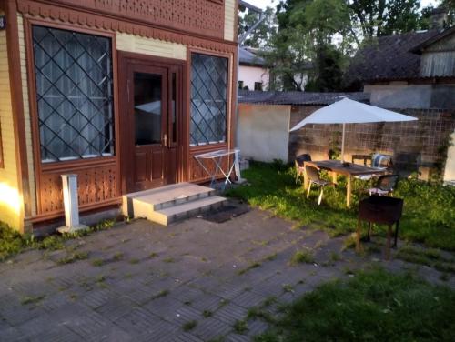 a patio with a table and an umbrella at Apartments Londa in Jūrmala