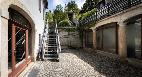 a stairway leading up to a building with a ladder at Pension Donatus in Pirna