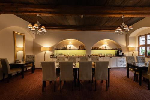 a dining room with a table and chairs at Pension Donatus in Pirna