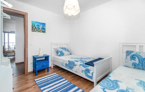a bedroom with two beds and a table and a mirror at Abby in Dramalj