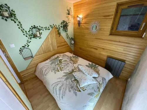 a small bedroom with a bed in a room at Haut Doubs Belvédère in Les Hôpitaux-Neufs