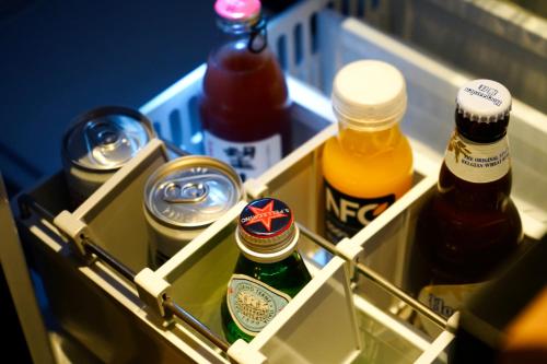 a drawer in a refrigerator filled with bottles of beer at POKKEI Hotel Shaoxing in Shaoxing