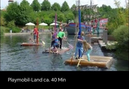 a group of people on a raft in the water at Goldener Anker Pottenstein Urlaub für die ganze Familie in Pottenstein