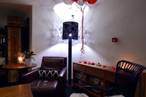 a living room with a chair and a lamp at Townhouse Hotel in Wagga Wagga