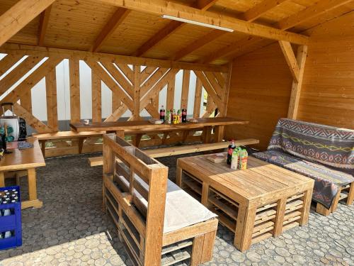 a wooden cabin with a table and a bench at Apartament D&D in Gorlice