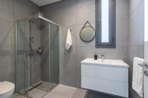 a bathroom with a shower and a toilet and a sink at Villa Flora's 3-Bedroom Retreat with Private Pool in Paralimni
