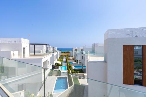a view from the balcony of a building with a swimming pool at Villa Flora's 3-BR Retreat & Private Pool in Protaras in Paralimni