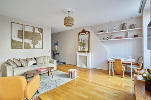 un salon avec un canapé et une table dans l'établissement Apartement Champs Elysée by Studio prestige, à Paris