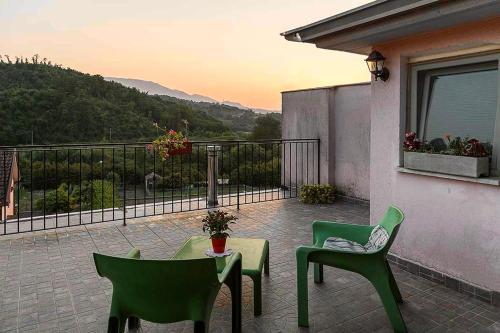 a patio with two chairs and a table and chairs at Coccinella B&B a Tufo in Tufo