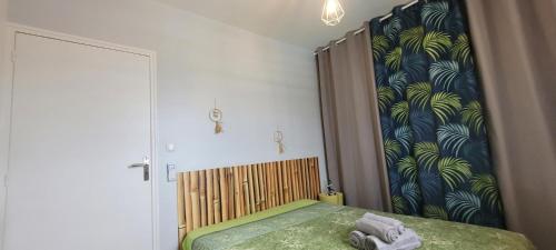 a bedroom with a bed with a wooden head board at VILLA CARAIBES vue mer exceptionnelle in Le Marin