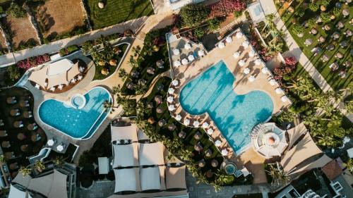 an overhead view of a pool at a resort at St George Beach Hotel & Spa Resort in Paphos