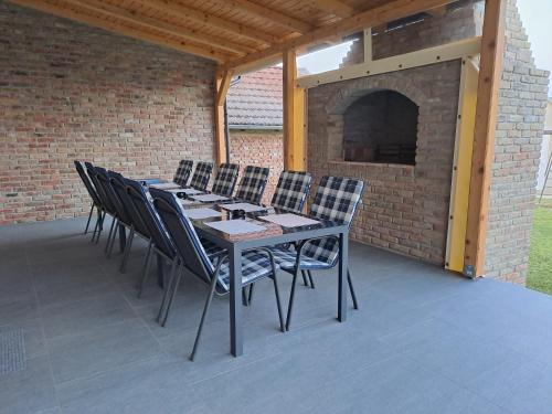 a table and chairs on a patio with a fireplace at Tamaris in Vukovar