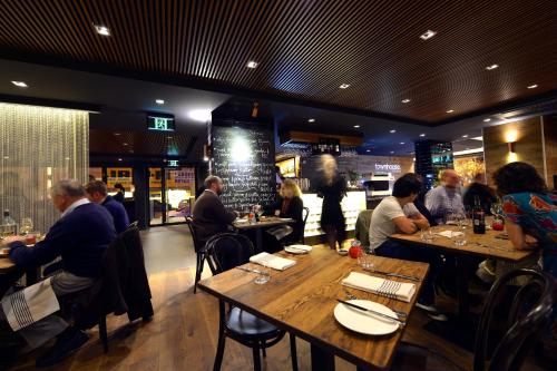 a group of people sitting at tables in a restaurant at Townhouse Hotel in Wagga Wagga
