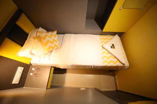 a small room with a bed in the ceiling at CABIN STAY-SOCIAL HUBZ in Mumbai