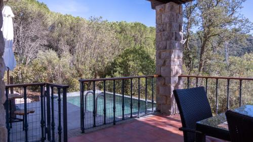 a balcony of a house with a swimming pool at Quinta das Murgas in Bucelas
