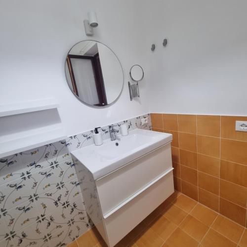 a bathroom with a sink and a mirror at La Villa di Nino in Ustica