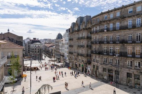 a group of people walking on a city street at Hotel Alda Puerta Del Sol in Vigo