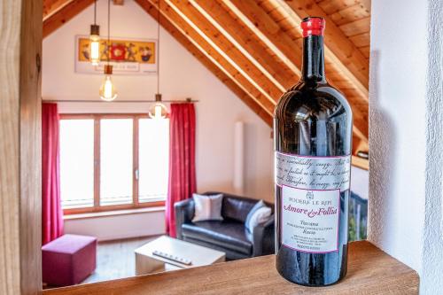 a bottle of wine sitting on a table in a living room at Hirschen Erlinsbach Swiss Quality in Erlinsbach