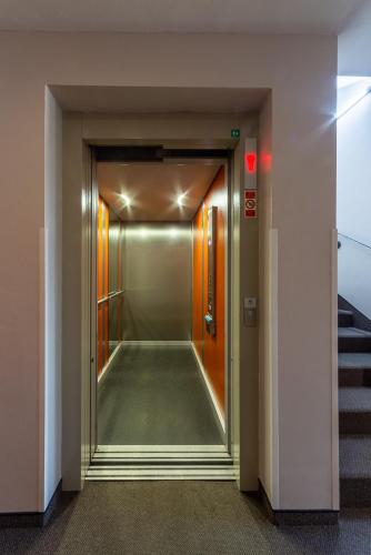 a hallway of a building with a door and stairs at Minimino hotel in Prague