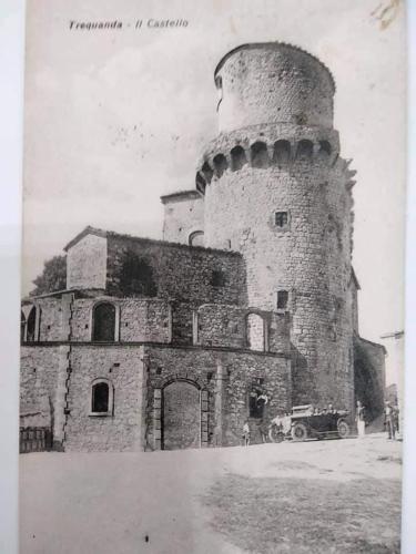 an old photo of a building with a tower at CasaMoira in Trequanda