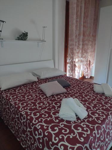a bedroom with a bed with two pillows on it at B&B L'Orchidea in Pisa