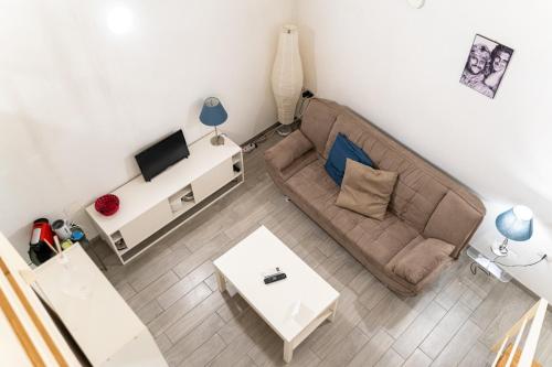 a living room with a couch and a table at Santa Maria degli Angeli Apartment in Naples