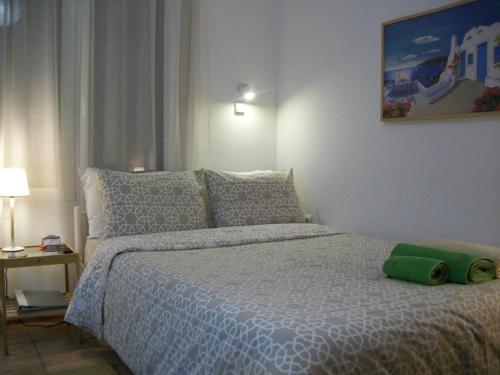 a bedroom with a bed with a green pillow on it at Acropolis studio with breathtaking city view in Athens