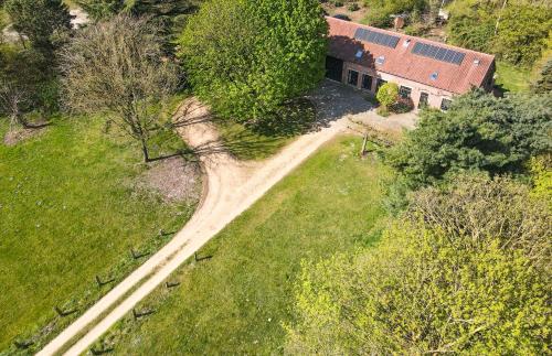 an aerial view of a house with a dirt road at Villa Vigor in Peer