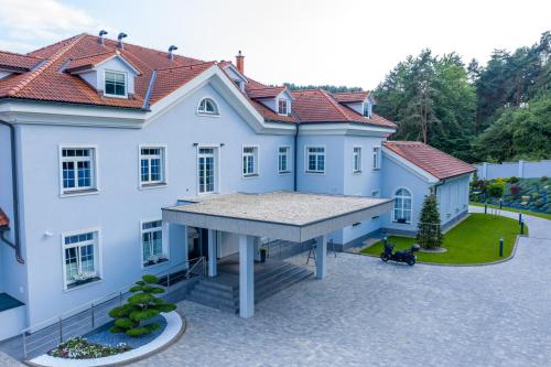 a large white house with a large roof at SP resort - Peter Sagan in Žilina