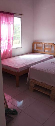a bedroom with two beds and a window at Casa Ayangue in Santa Elena
