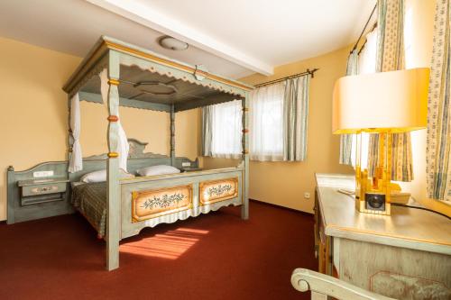 a bedroom with a canopy bed in a room at Aquamarina Hotel Visegrád in Visegrád