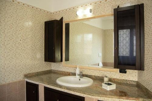 a bathroom with a sink and a mirror at marath houses 1 in Marta