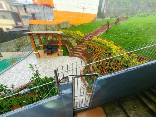a view of a garden with a table and stairs at Mirador Modern House - Walking distance to Lourdes Grotto in Baguio