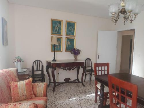 a living room with a table and chairs and a couch at Balcón de Aguilar in Aguilar de la Frontera