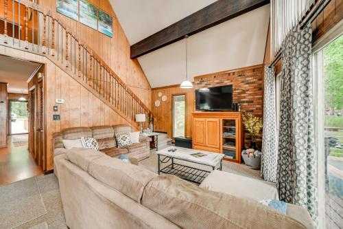 a living room with a couch and a tv at Cozy Dover Home with Boat Dock, Fire Pit and Deck! in Dover