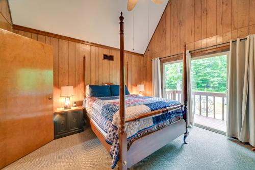 a bedroom with a bed and a large window at Cozy Dover Home with Boat Dock, Fire Pit and Deck! in Dover