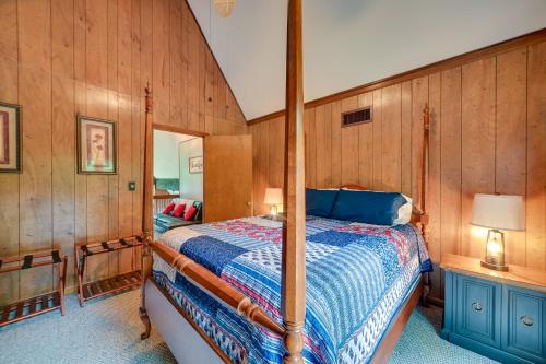 a bedroom with a bed in a room with wooden walls at Cozy Dover Home with Boat Dock, Fire Pit and Deck! in Dover