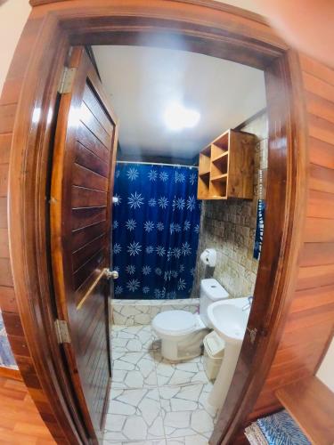 a bathroom with a toilet and a sink at Casa Lobos in Lobitos
