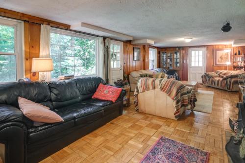 a living room with a black leather couch at Bethesda Apartment and Yard about 9 Mi to D C in Bethesda