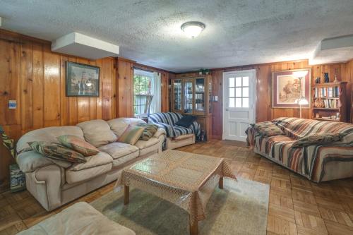 a living room with a couch and a table at Bethesda Apartment and Yard about 9 Mi to D C in Bethesda